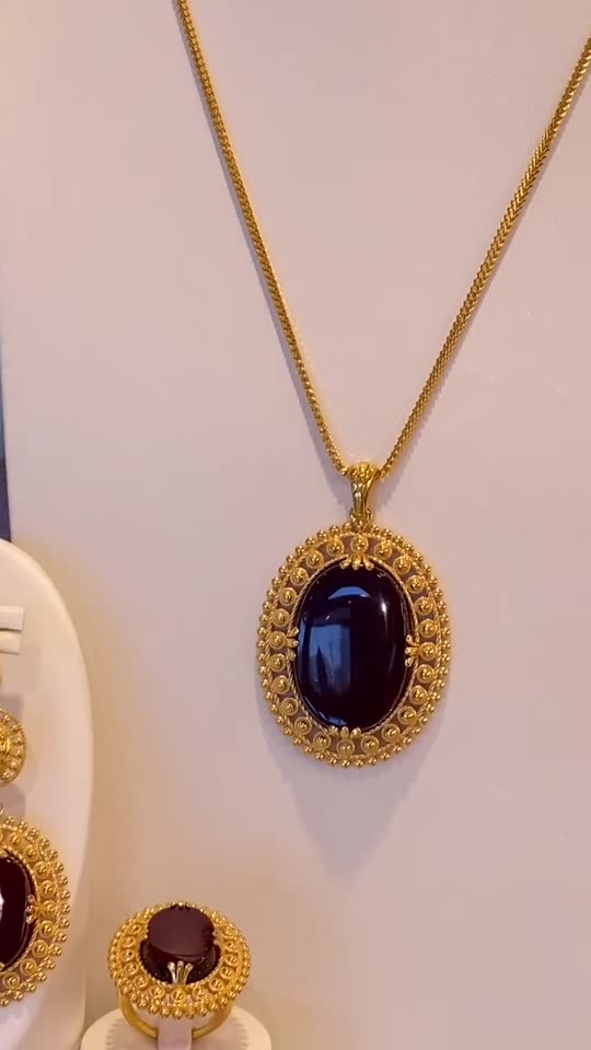 A 21 carat gold necklace set with dark red aqeeq stones, made to order at Aroos Jewellers